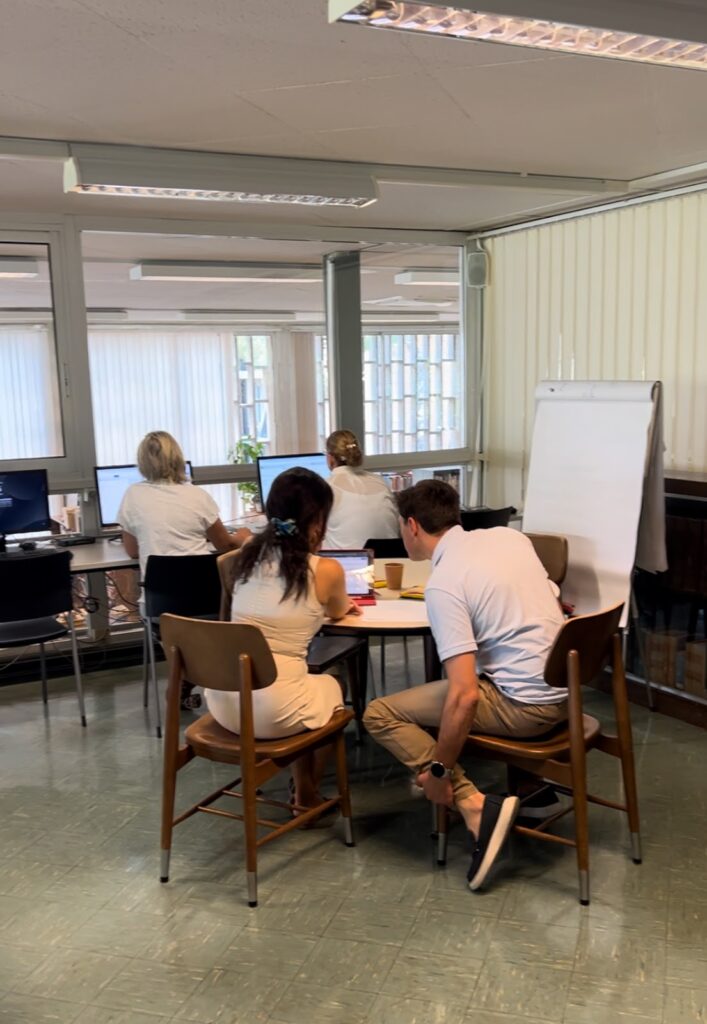 Teachers from Athens College look at a sample micro-credential together.