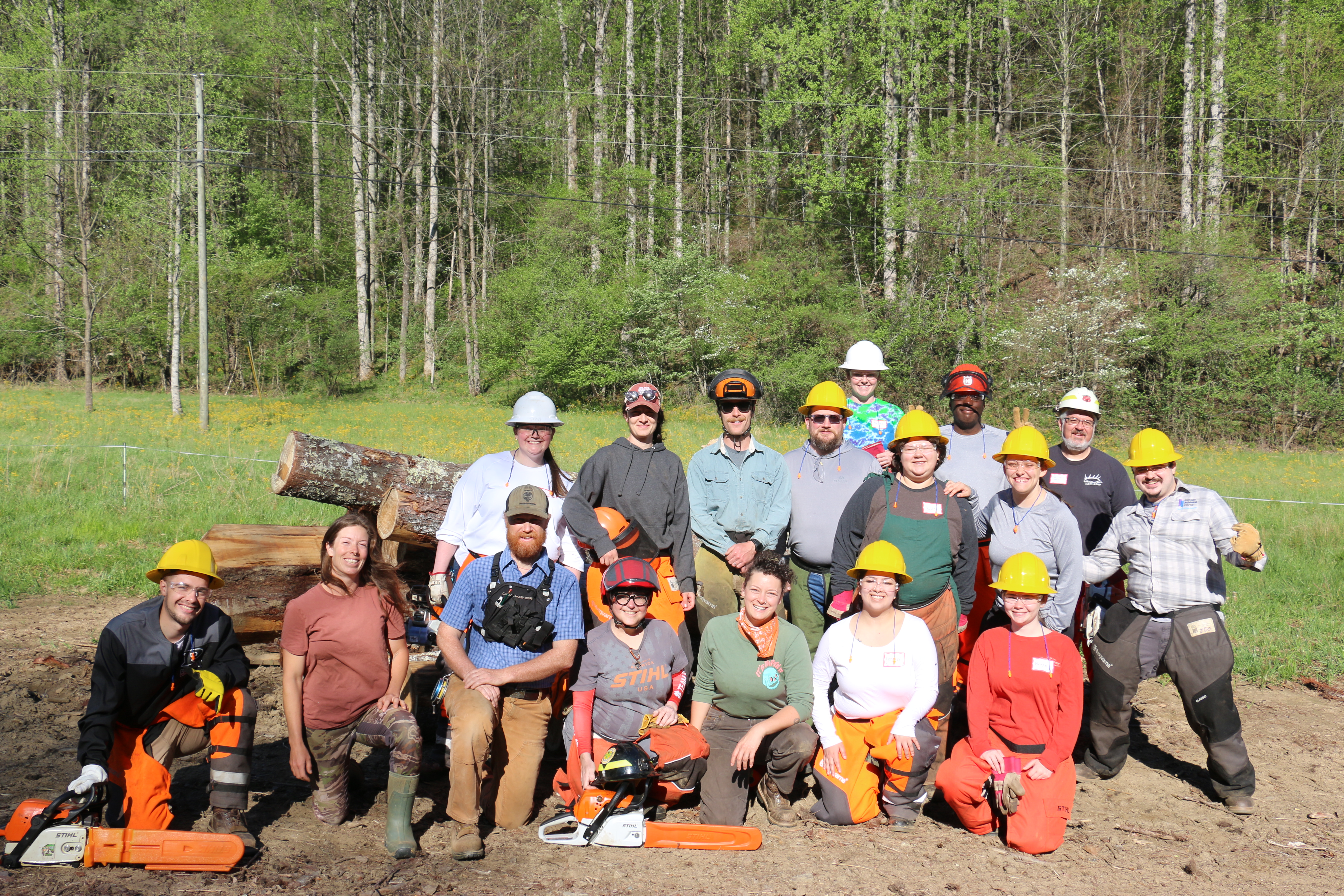 Appalachian State Advise NC Advisers pose with chainsaw safety instructors at Full Moon Farms in Deep Gap, NC.