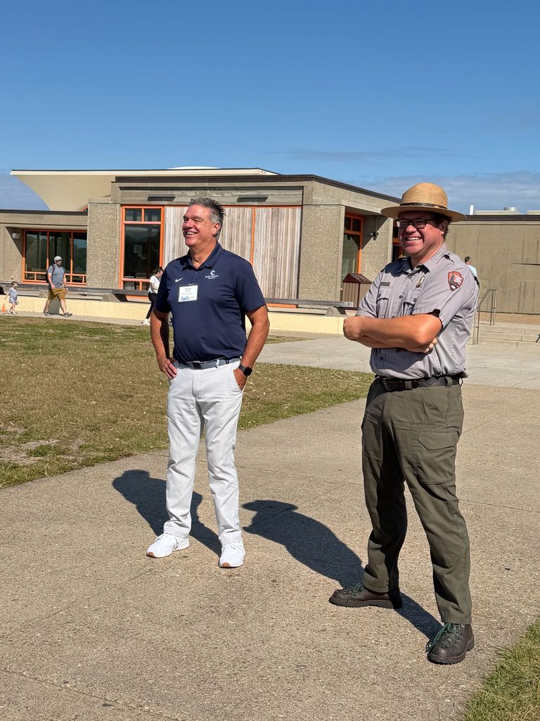 Dare County hosts the AAERO Network for the kick-off event Sept. 27-29. Dare County Schools Superintendent Steve Basnight stands beside National Park Service Ranger at Wright Brother's Memorial.  